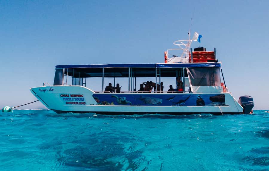 Coral Bay Glass-Bottom Boat Tour - Boarding Nhanya-Ku from Coral Bay beach